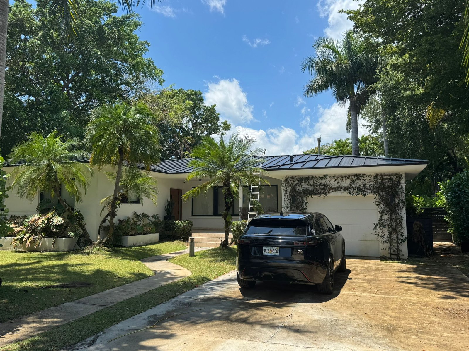 Standing-seam metal roof installation by Moura Construction